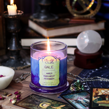 Load image into Gallery viewer, A lit blue soy candle with swirls of purple wax spreading through it. Label reads &quot;Gale, Amber, Parchment, Persimmon. Baldur&#39;s Gate 3 Inspired Candle&quot;
