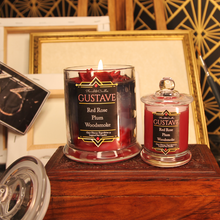 Load image into Gallery viewer, Both sizes of our Gustave inspired candle. The smaller jar is a plain red colour.
The label reads "Planeshift Candles - Gustave - Red Rose, plum, woodsmoke - Clair Obscur expedition 33 inspired soy candles."
