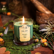 Load image into Gallery viewer, A lit light green soy candle with swirls of ochre brown wax spreading through it. Label reads &quot;Halsin, Oakmoss, Honey, Basil. Baldur&#39;s Gate 3 Inspired Candle&quot;
