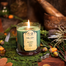 Load image into Gallery viewer, A lit light green soy candle with swirls of ochre brown wax spreading through it. Label reads "Halsin, Oakmoss, Honey, Basil. Baldur's Gate 3 Inspired Candle"