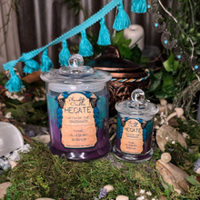 Load image into Gallery viewer, Large and Small Hecate candles in teal and purple wax poured in clear glass jars with lids.