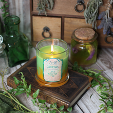 Load image into Gallery viewer, A light green and golden yellow candle surrounded by vines, books and herbs. Label reads "Jaheira - Lotus, Black Tea, Figs- Baldur's Gate 3 Inspired Candle"