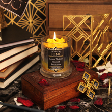 Load image into Gallery viewer, A yellow, black and grey candle inspired by Lune from Clair Obscur: Expedition 33. Label reads "Planeshift Candles - Lune - lemon verbena, hyacinth, parchment"