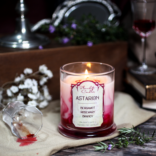 A lit white soy candle with swirls of blood red wax spreading through it. Label reads 