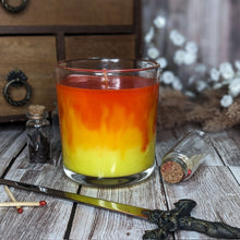 Load image into Gallery viewer, A custom candle with a  "complex colour" selection of oranges and  yellow wax marbled like fire.
