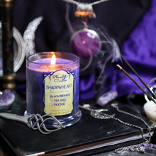 Load image into Gallery viewer, A deep purple and navy blue candle surrounded by incense, crescent moons and books. Label reads "Shadowheart -Black Orchids - Tea Rose - Incense.  Baldur's Gate 3 Inspired Candle"
